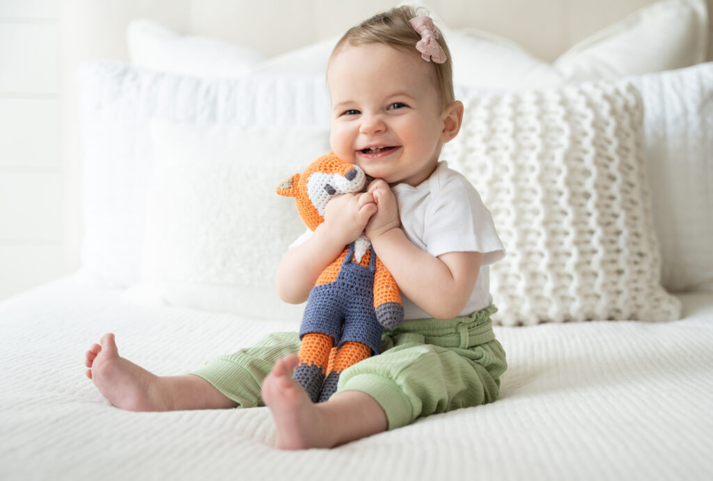 Little girl holding stuffed animal