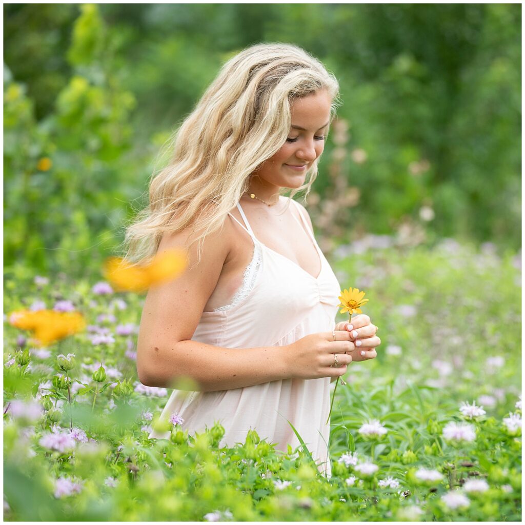 Senior holding Flower as Prop