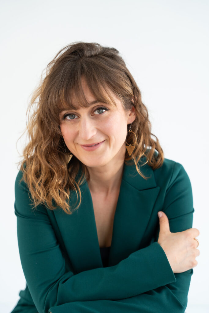 headshot of woman in green blazer
