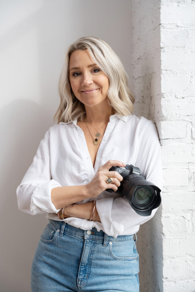 headshot of Meghan Doll holding her camera