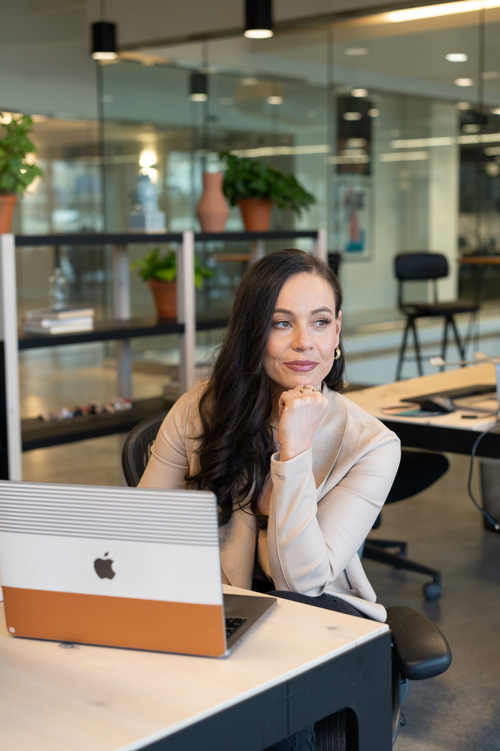 Woman sitting at desk in natural work environment
