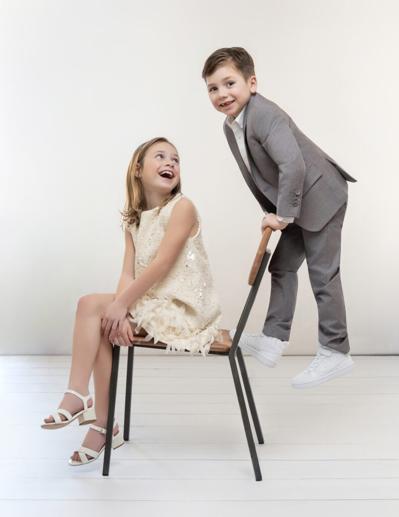 Modern portrait of siblings acting silly and laughing