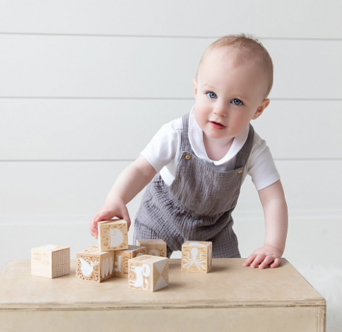 Photo of 1 year old baby boy playing with blocks
