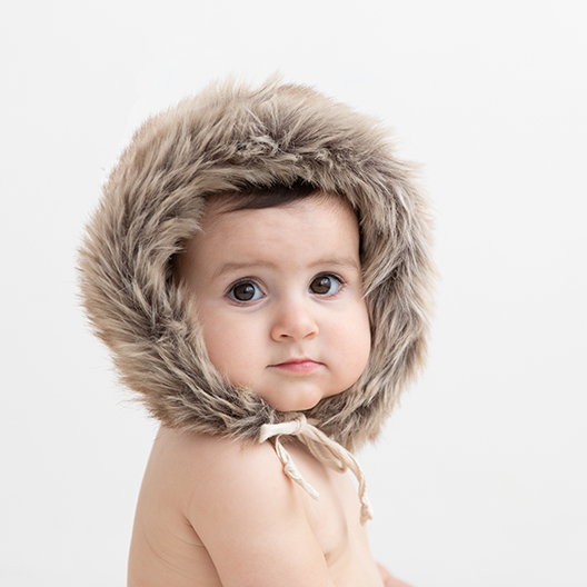 baby wearing a fur hat shot by meghan doll photography