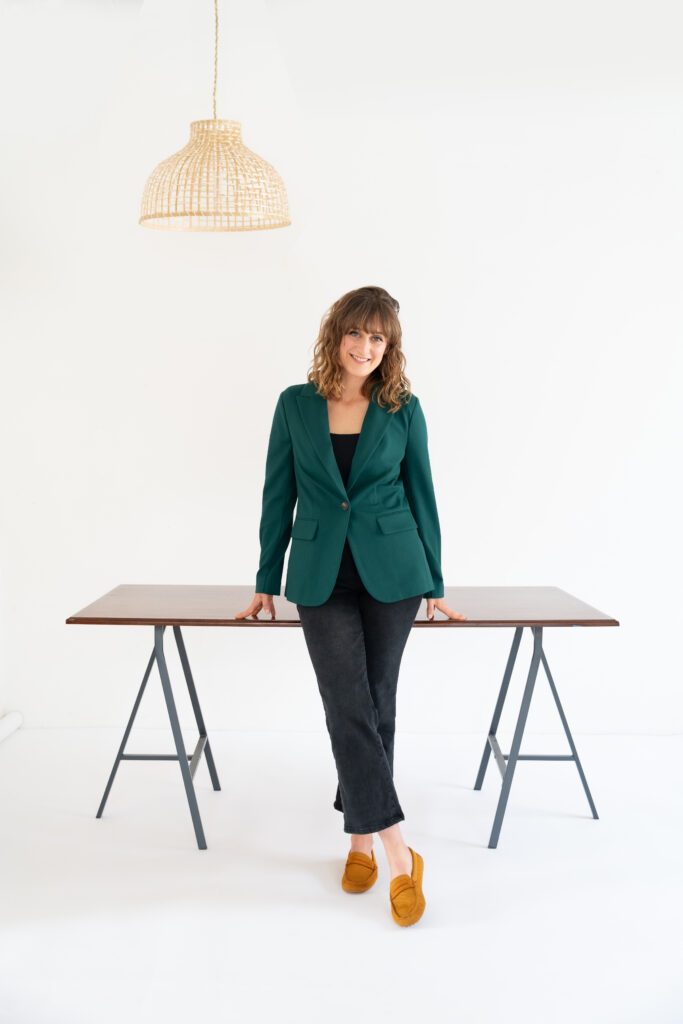 professional woman standing in front of empty desk