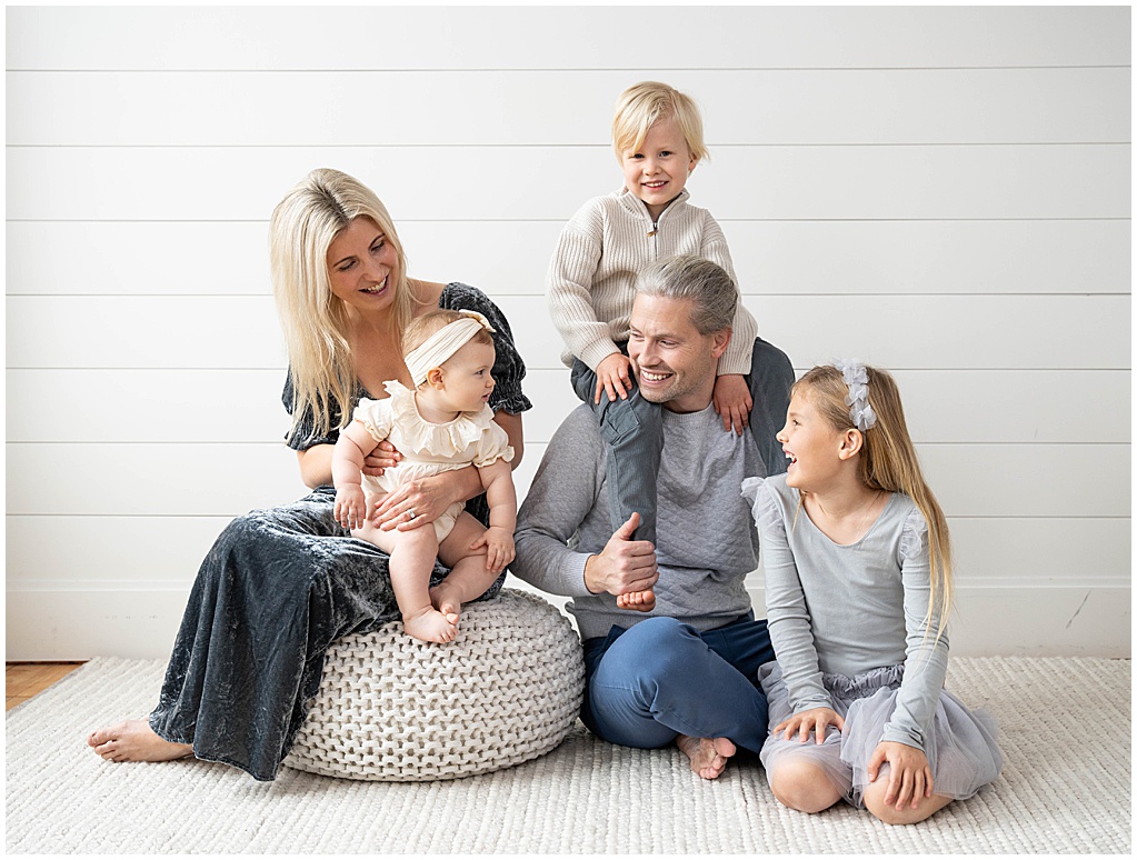 Family of 5 in blue tones having fun for family portrait